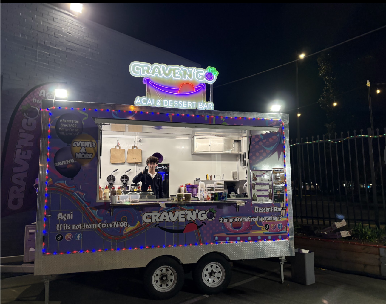 Crave 'N' Go acai & dessert bar food truck lit up at night